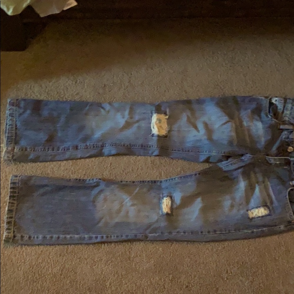 Ripped jeans with silk patches.